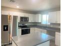 Beautiful kitchen with stainless steel appliances, granite countertops, and white cabinets at 2632 E Irwin Ave, Mesa, AZ 85204