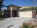 Inviting single-story home with a wide driveway leading to a two-car garage at 2830 W Grenadine Rd, Phoenix, AZ 85041