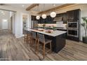 Modern kitchen featuring a large island with counter seating, pendant lighting, and stainless steel appliances at 3892 W Antelope Way, San Tan Valley, AZ 85144