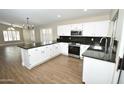 Modern kitchen featuring granite countertops, stainless steel appliances, white cabinetry, and natural light at 4002 E Rockwood Dr, Phoenix, AZ 85050