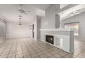 Spacious living room featuring tile flooring, vaulted ceilings, with fireplace and neutral color palette at 4041 W Cielo Grande --, Glendale, AZ 85310