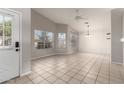 Open living room featuring tile flooring, vaulted ceiling, and plenty of natural light from dual paned windows at 4041 W Cielo Grande --, Glendale, AZ 85310