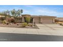 Charming home featuring a three-car garage and desert landscaping at 42123 N Long Cove Way, Anthem, AZ 85086