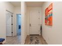 Inviting entryway featuring tile floors, neutral walls, and a stylish art piece at 4332 N 197Th Dr, Litchfield Park, AZ 85340