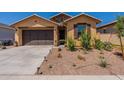 Charming single-story home featuring a manicured front yard and a two-car garage at 4332 N 197Th Dr, Litchfield Park, AZ 85340