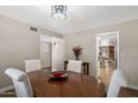 Dining room features a round table and wood floors, with views to other rooms in the home at 4619 E Farmdale Ave, Mesa, AZ 85206