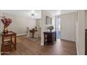 Inviting entryway featuring wood-look tile floors and an adjacent dining area with elegant furnishings at 4619 E Farmdale Ave, Mesa, AZ 85206