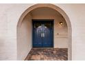 Close up of the double blue front door with an arched entryway and brick pavers at 6036 E Windsor Ave, Scottsdale, AZ 85257