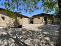 Spacious backyard featuring desert landscaping and access between two detached buildings at 7226 N 31St Ave, Phoenix, AZ 85051