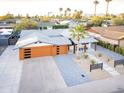 Expansive aerial view of a stylish home featuring a modern garage, desert landscaping, and mountain views at 8114 E Arlington Rd, Scottsdale, AZ 85250