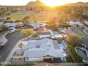 Panoramic aerial view of neighborhood with multiple homes and swimming pools with a mountain backdrop at 8114 E Arlington Rd, Scottsdale, AZ 85250