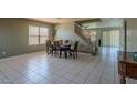 Spacious dining room with large windows, a chandelier, and a staircase with natural light at 8163 E Posada Ave, Mesa, AZ 85212