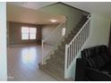 View of entryway with stairs leading upstairs and a living room to the left at 8163 E Posada Ave, Mesa, AZ 85212