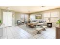 Inviting living room featuring neutral decor, a plush sofa, and ample natural light at 8163 E Posada Ave, Mesa, AZ 85212