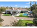 Aerial view of a private backyard with a pool, outdoor seating, and putting green, perfect for entertaining at 10050 N 58Th St, Paradise Valley, AZ 85253