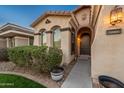 The front of this home shows a front door with an arched entryway and well-kept landscaping at 10772 W Woodland Ave, Avondale, AZ 85323
