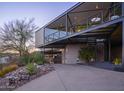 Unique modern home showcasing clean lines, an elevated design, desert landscaping, and exterior staircase at 1340 E Las Palmaritas Dr, Phoenix, AZ 85020