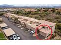 An aerial view shows a desirable townhome with tile roof and spacious driveway in a well-maintained community at 13700 N Fountain Hills Blvd # 365, Fountain Hills, AZ 85268
