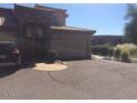 View of a tan home with a two-car garage surrounded by desert landscaping at 13700 N Fountain Hills Blvd # 365, Fountain Hills, AZ 85268