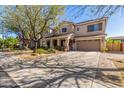 Beautiful two-story home with a well-manicured lawn, covered porch, and convenient two-car garage at 14363 W Acapulco Ln, Surprise, AZ 85379