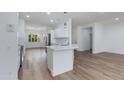 Open kitchen with white cabinets and stainless steel appliances at 15046 W Cooperstown Way, Surprise, AZ 85374
