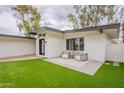 Backyard with green lawn and outdoor seating area with two chairs and a table at 15255 N 5Th Ln, Phoenix, AZ 85023