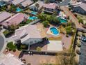 An aerial view of the private backyard with a pool and a sports court, surrounded by mature landscaping at 16428 N 39Th Pl, Phoenix, AZ 85032