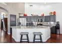 Kitchen with granite countertops, grey cabinetry, stainless steel appliances, and breakfast bar at 16428 N 39Th Pl, Phoenix, AZ 85032