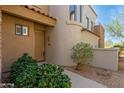 Charming doorway of home with tile roofing and desert landscaping at 19550 N Grayhawk Dr # 1044, Scottsdale, AZ 85255