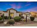 Attractive desert landscaping frames this charming single-story home with a tile roof at 25454 N 73Rd Ave, Peoria, AZ 85383