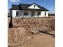 A single-story home featuring a white exterior, a dark roof, and a covered porch with wooden columns at 28003 N Faded Creek Dr, Florence, AZ 85132