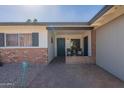 Inviting front porch with brick accents, covered entry and space to relax at 3015 E Dahlia Dr, Phoenix, AZ 85032