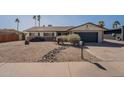 Well-maintained front yard with desert landscaping, offering curb appeal at 3015 E Dahlia Dr, Phoenix, AZ 85032