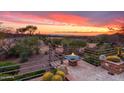 Inviting patio view with a fire pit and desert sunset backdrop at 40478 N 108Th Pl, Scottsdale, AZ 85262