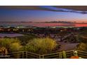 Distant city lights and mountain views from backyard patio at twilight at 40478 N 108Th Pl, Scottsdale, AZ 85262