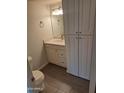 Cozy powder room featuring modern vanity, mirror, and convenient storage cabinets at 4304 N Parkway Ave, Scottsdale, AZ 85251