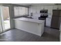 Bright kitchen featuring white cabinets, stainless steel appliances, and granite countertops at 4304 N Parkway Ave, Scottsdale, AZ 85251