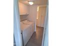 Convenient laundry room with white washer and dryer and ample cabinet space at 4304 N Parkway Ave, Scottsdale, AZ 85251