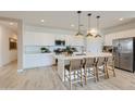 Modern kitchen with white cabinetry, quartz countertops, stainless steel appliances, and a large kitchen island at 4661 E French Rd, San Tan Valley, AZ 85143