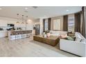 Bright open-concept living area featuring modern furnishings, a large island, and a neutral color scheme at 4661 E French Rd, San Tan Valley, AZ 85143