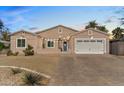 Well-lit single-story home boasting a brick driveway, two-car garage, and inviting curb appeal at 804 E Palmaire Ave, Phoenix, AZ 85020