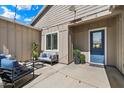 Inviting patio with stylish outdoor furniture, string lights, and a bright blue door at 804 E Palmaire Ave, Phoenix, AZ 85020