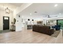 Spacious open floorplan with modern kitchen, dining area, and living room featuring light wood floors and stylish decor at 9331 S Lakeshore Dr, Tempe, AZ 85284