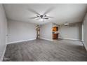 Open-concept living room features tile floors, a ceiling fan, and easy access to the kitchen at 10411 N 11Th Ave # 28, Phoenix, AZ 85021