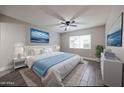 Bright main bedroom with a ceiling fan, large window, and contemporary decor at 10411 N 11Th Ave # 28, Phoenix, AZ 85021