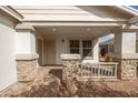 Inviting front porch with stone pillars and a paved walkway leading to the front door at 10656 E Plata Ave, Mesa, AZ 85212