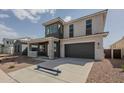 Stunning two-story home with a two-car garage, desert landscaping, and a welcoming covered porch at 11051 E Ulysses Ave, Mesa, AZ 85212