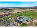 Expansive aerial view showcasing the community amenities, including pools, tennis courts, and a golf course at 11300 N Casa Dega Dr # 1069, Surprise, AZ 85388