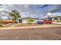 Attractive single-story home with a xeriscaped front yard, long driveway, and a spacious garage at 1340 E Townley Ave, Phoenix, AZ 85020