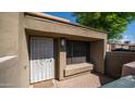 Close-up of front entrance with security door, tile patio, and unit number 712 at 1432 W Emerald Ave # 712, Mesa, AZ 85202